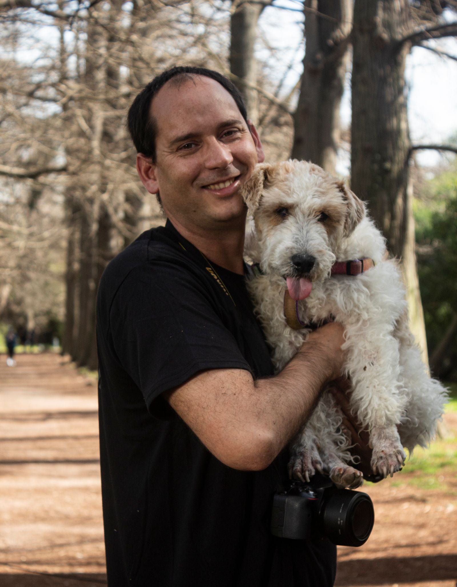 A smiling owner holding their dog